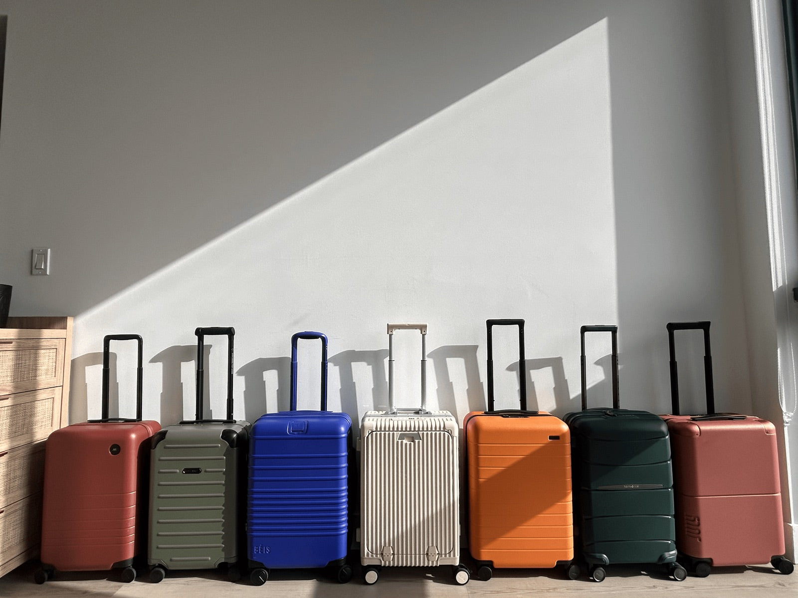 Five carry-on suitcases lined up for testing